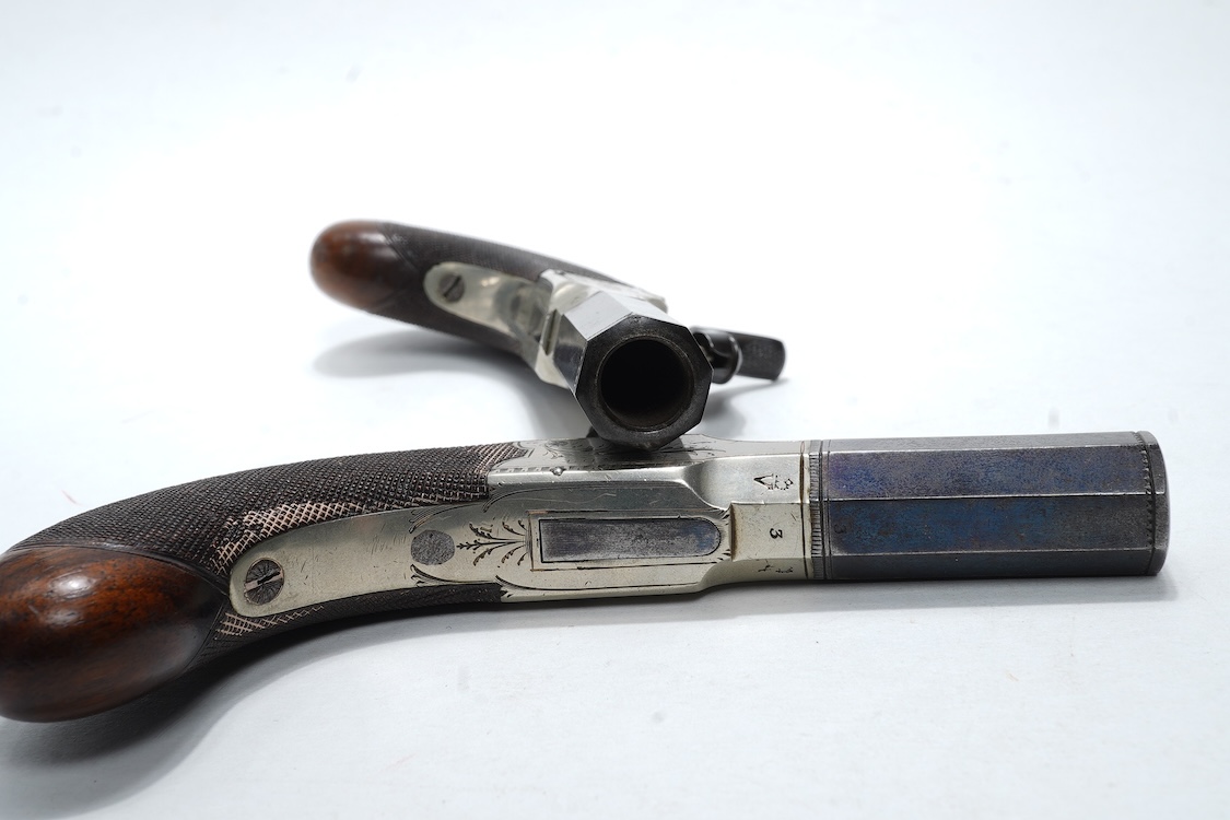 A pair of boxlock percussion pocket pistols with 4cm octagonal barrels, the frames engraved Lacy & Co., London, with London proof marks and rounded chequered walnut butts (2)